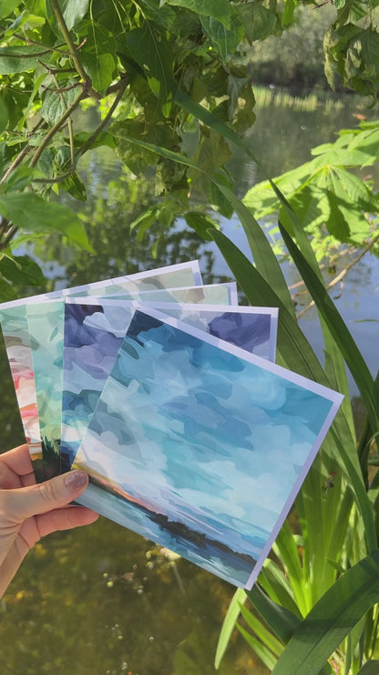 Slow motion video of abstract sky greeting card featuring blue twilight skies, glowing sunset reflections, and shimmering lake water during summer evening blue hour