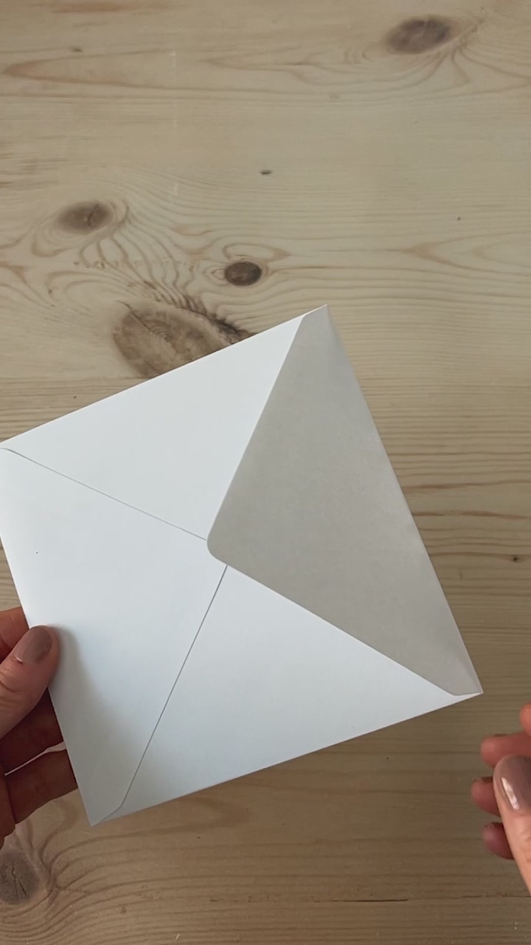 Slow motion video of contemporary abstract sky greeting card being removed from envelope featuring cobalt blue skies and glowing pink horizon light