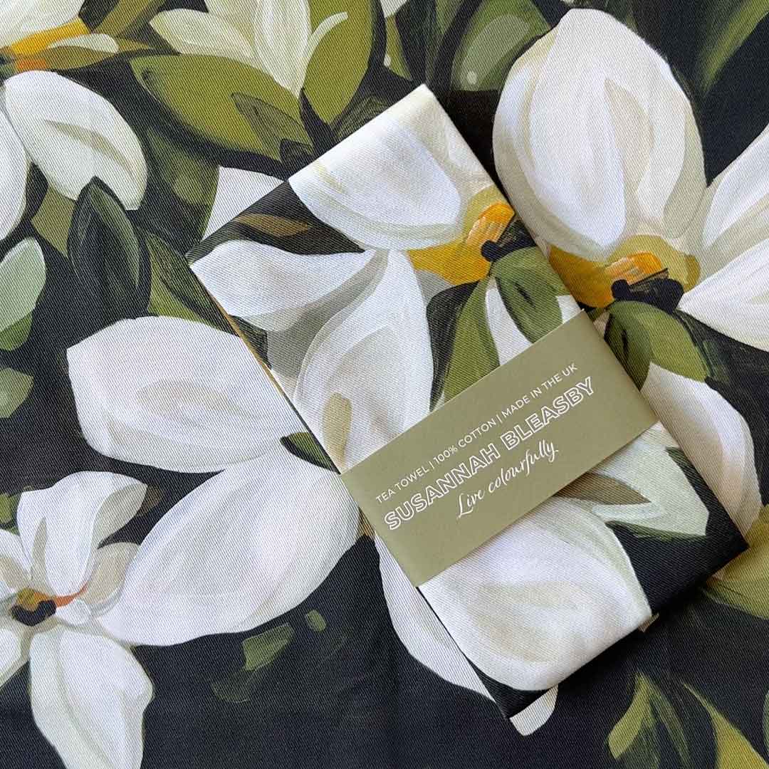 forest green and white flowers cotton tea towel on wooden table