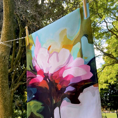 pink floral cotton tea towel hanging on line