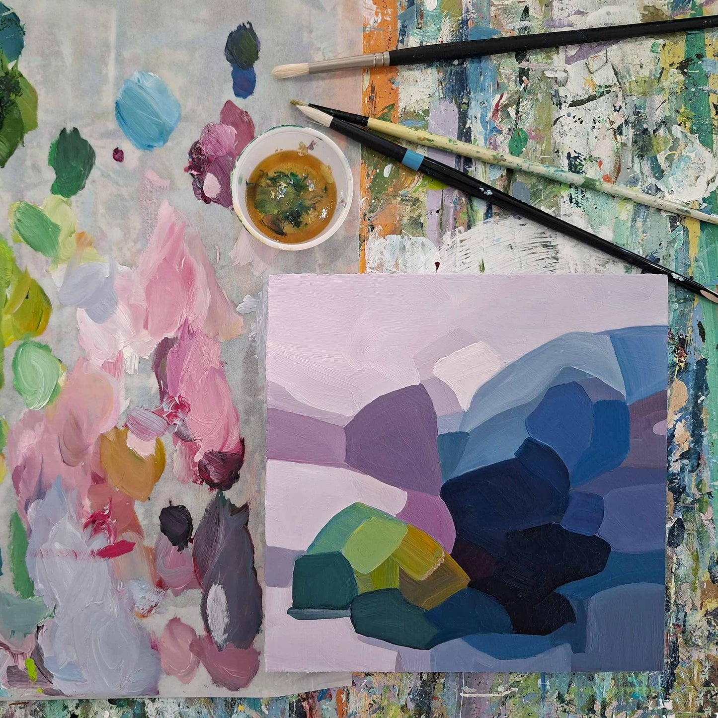 small blue and purple abstract oil painting on artist bench