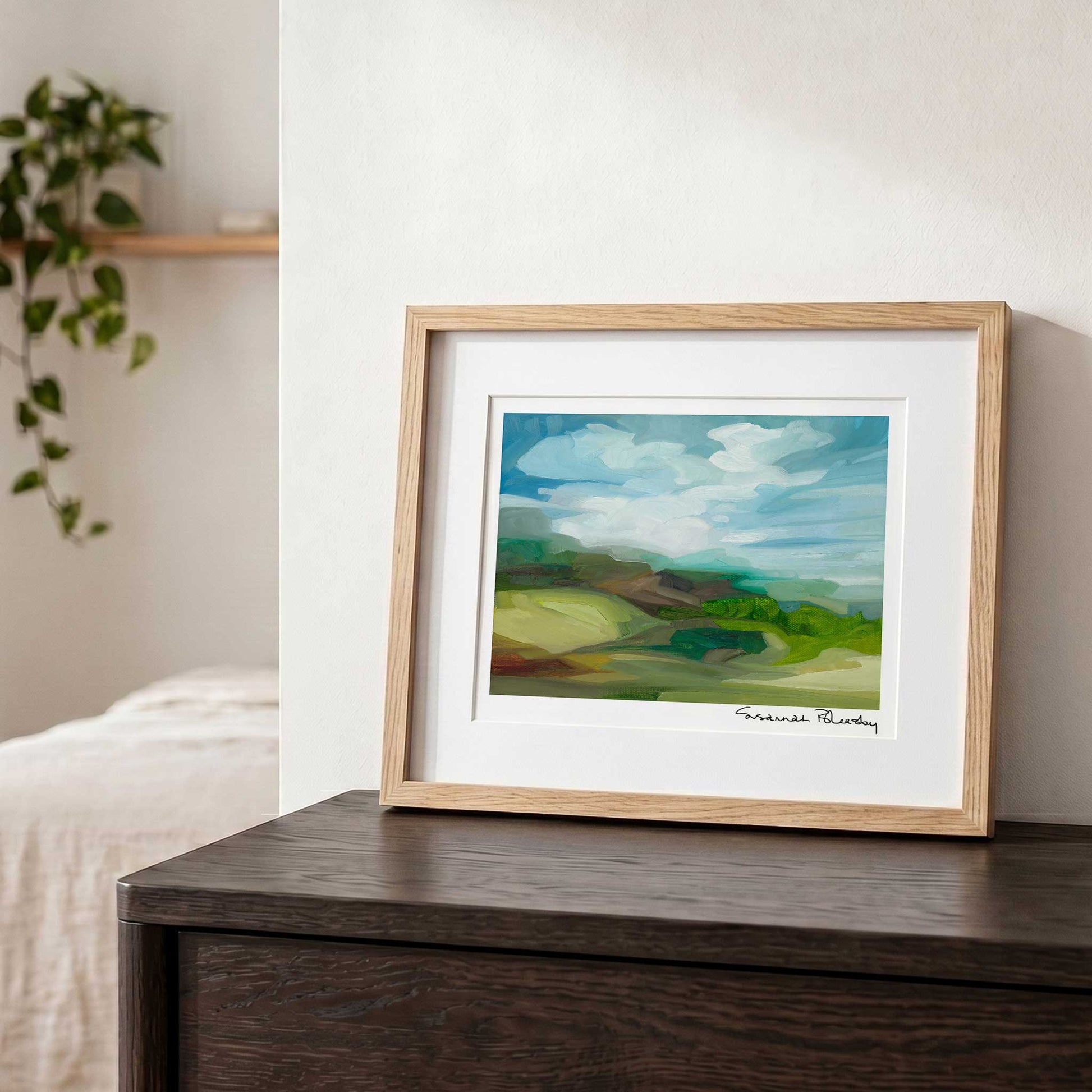 Contemporary countryside wall art featuring green hills, rocky ridges and expressive shapes and shadows.