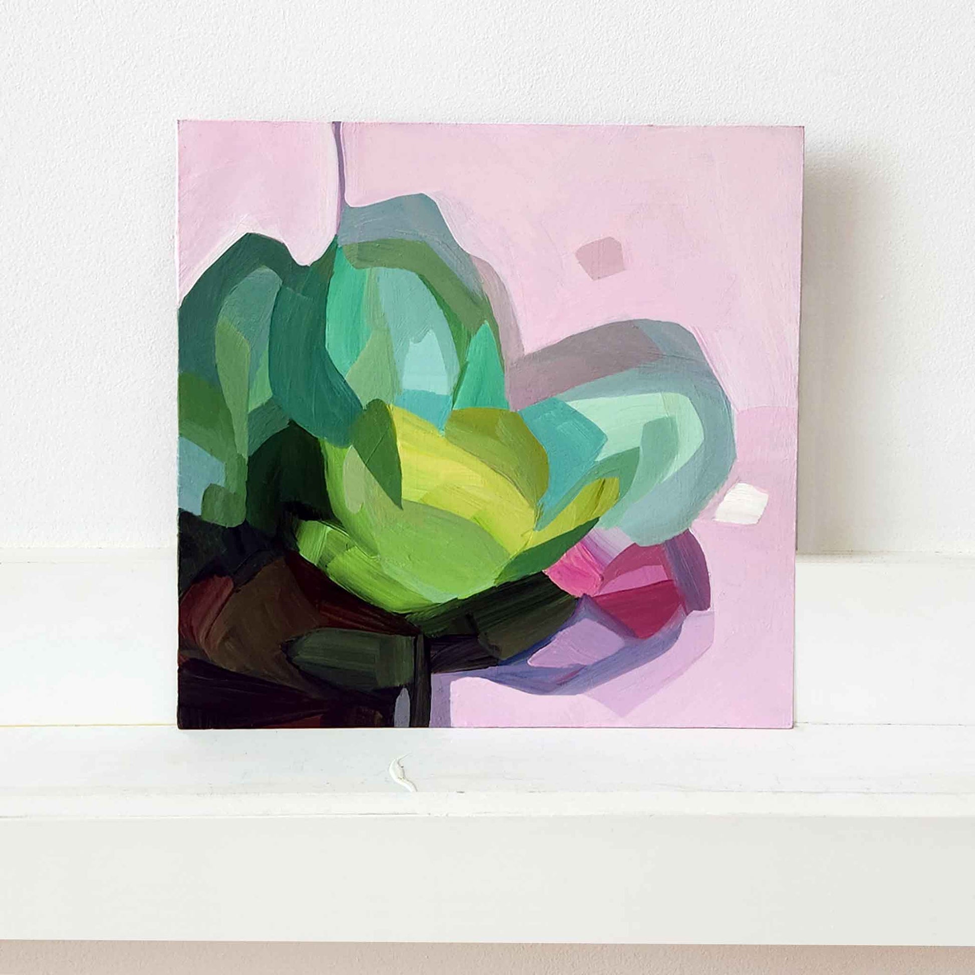 abstract flower painting in shades of green on pink background