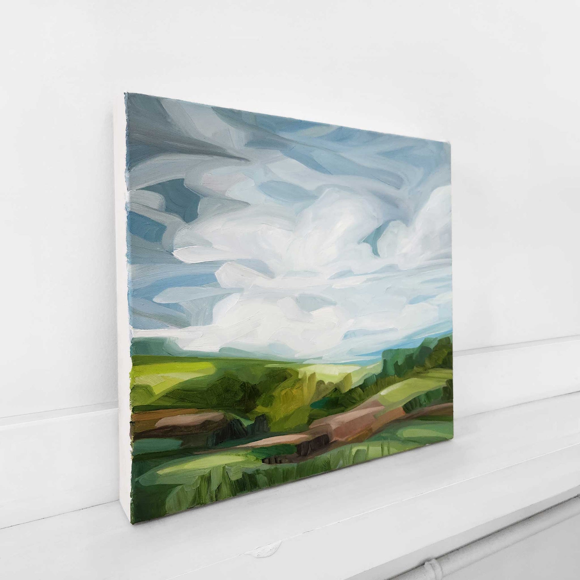 pastoral landscape oil painting with rolling green hills and a bright blue sky