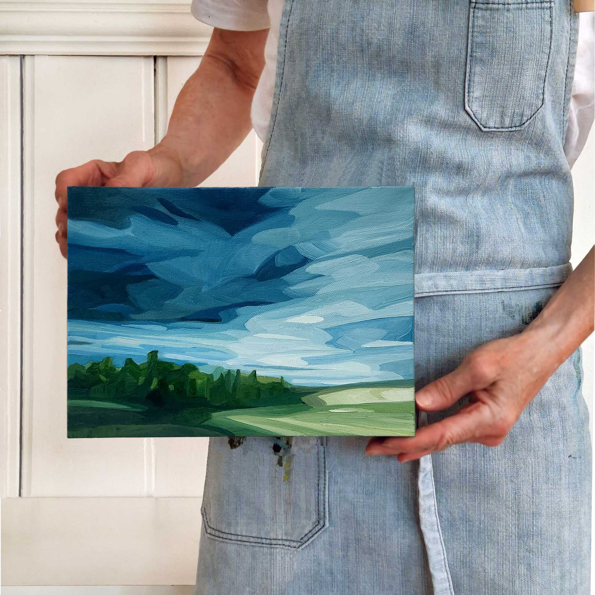 original oil painting of an approaching thunderstorm over a green field