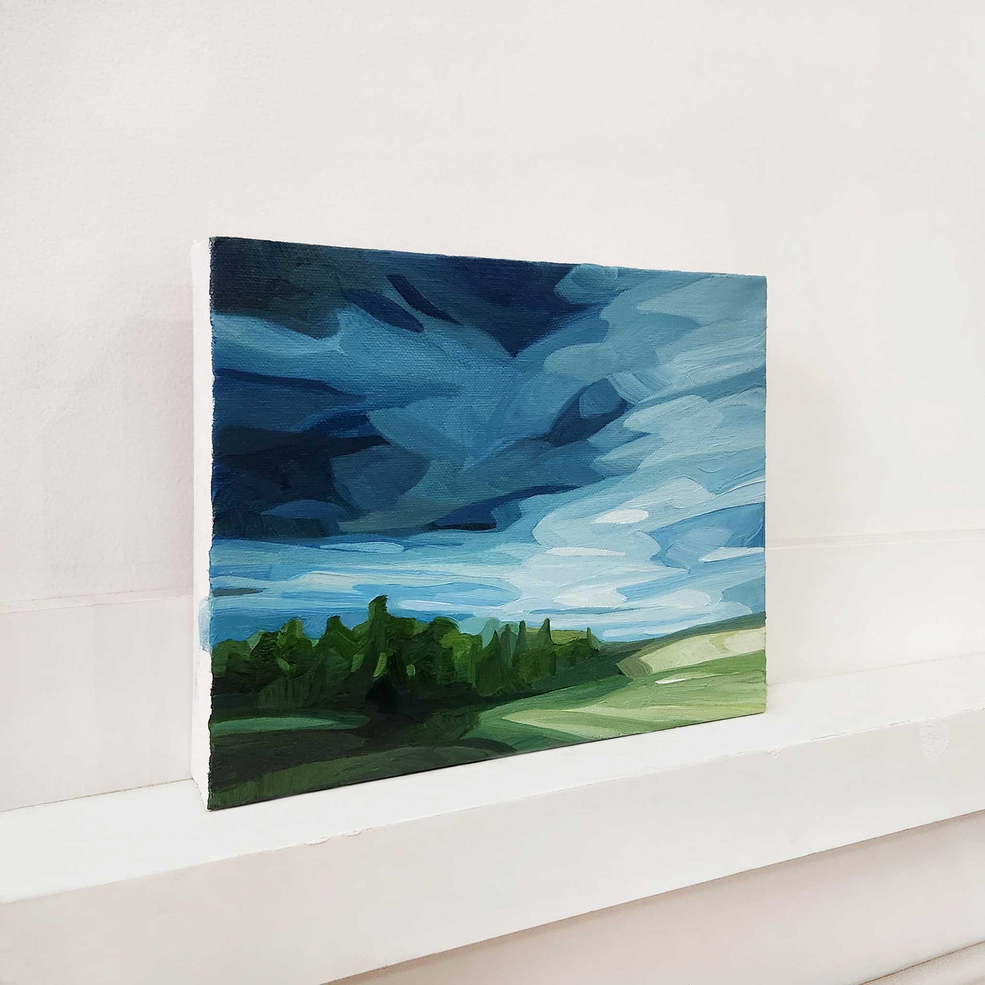 Atmospheric oil painting of a spring rainstorm over the countryside.