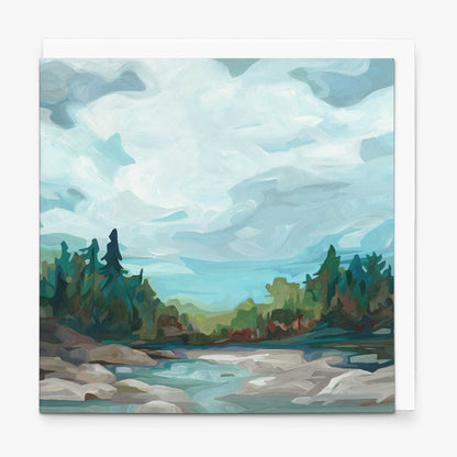 Contemporary landscape greeting card with blue-grey skies, crystal clear water, and forested shoreline scenery