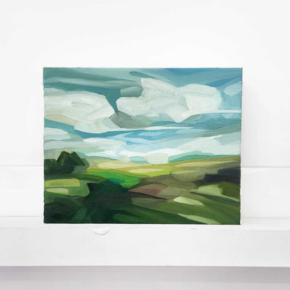 Original oil painting of a summer countryside with lush green fields under a vivid blue sky.