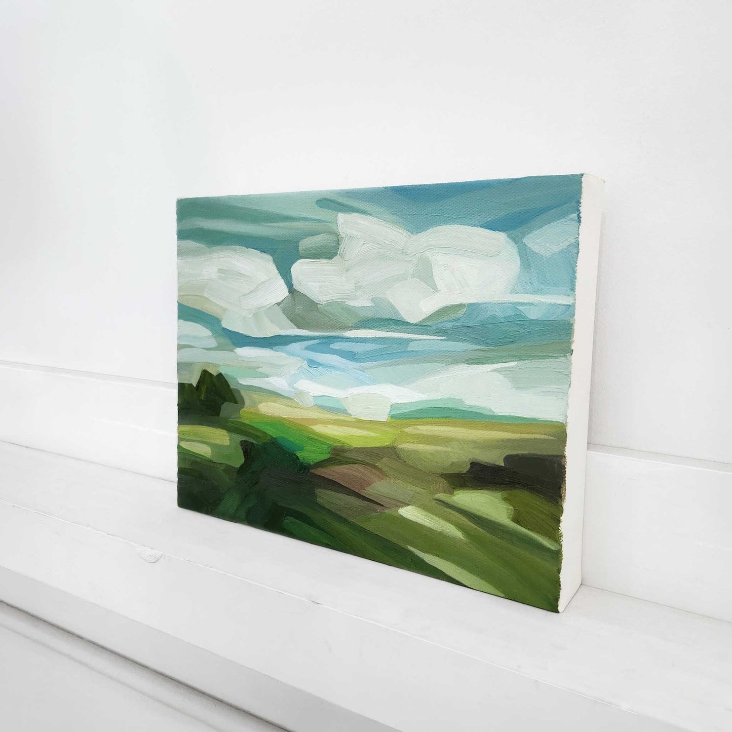 Summer countryside oil painting with vibrant green fields beneath a bright blue sky.