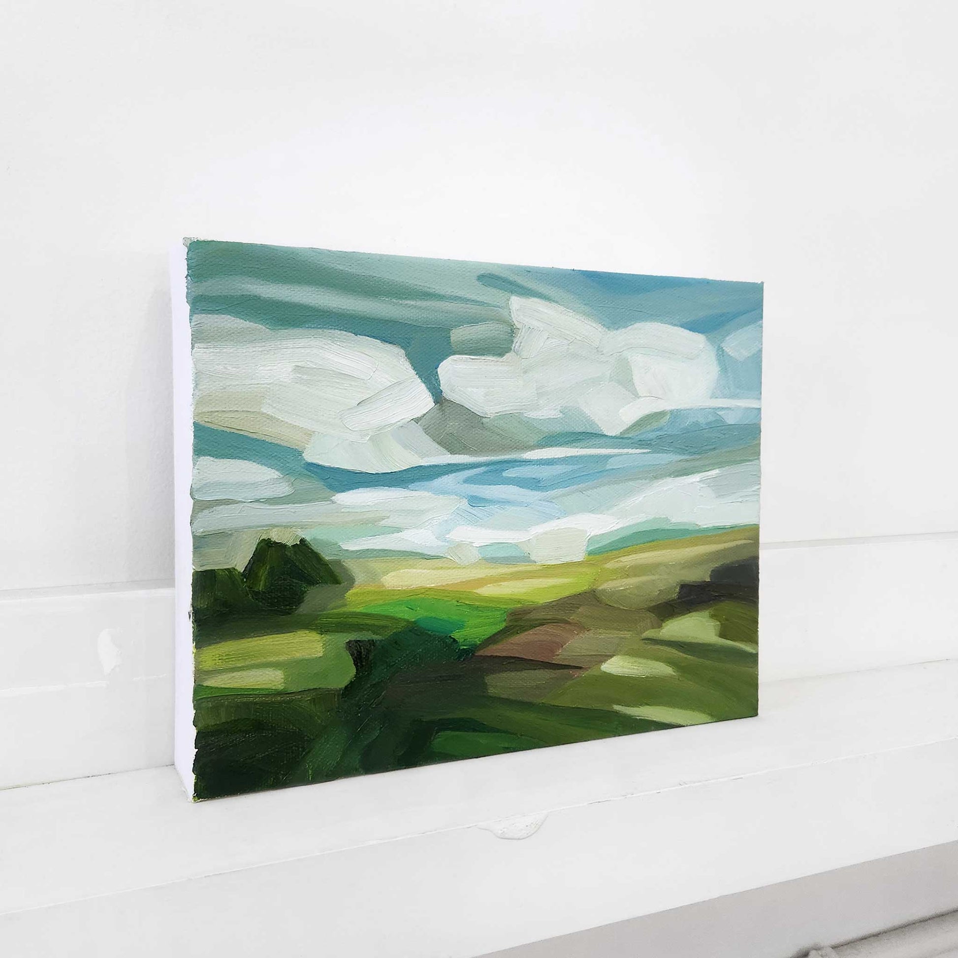 Original landscape painting of a sunny countryside under expansive blue skies.