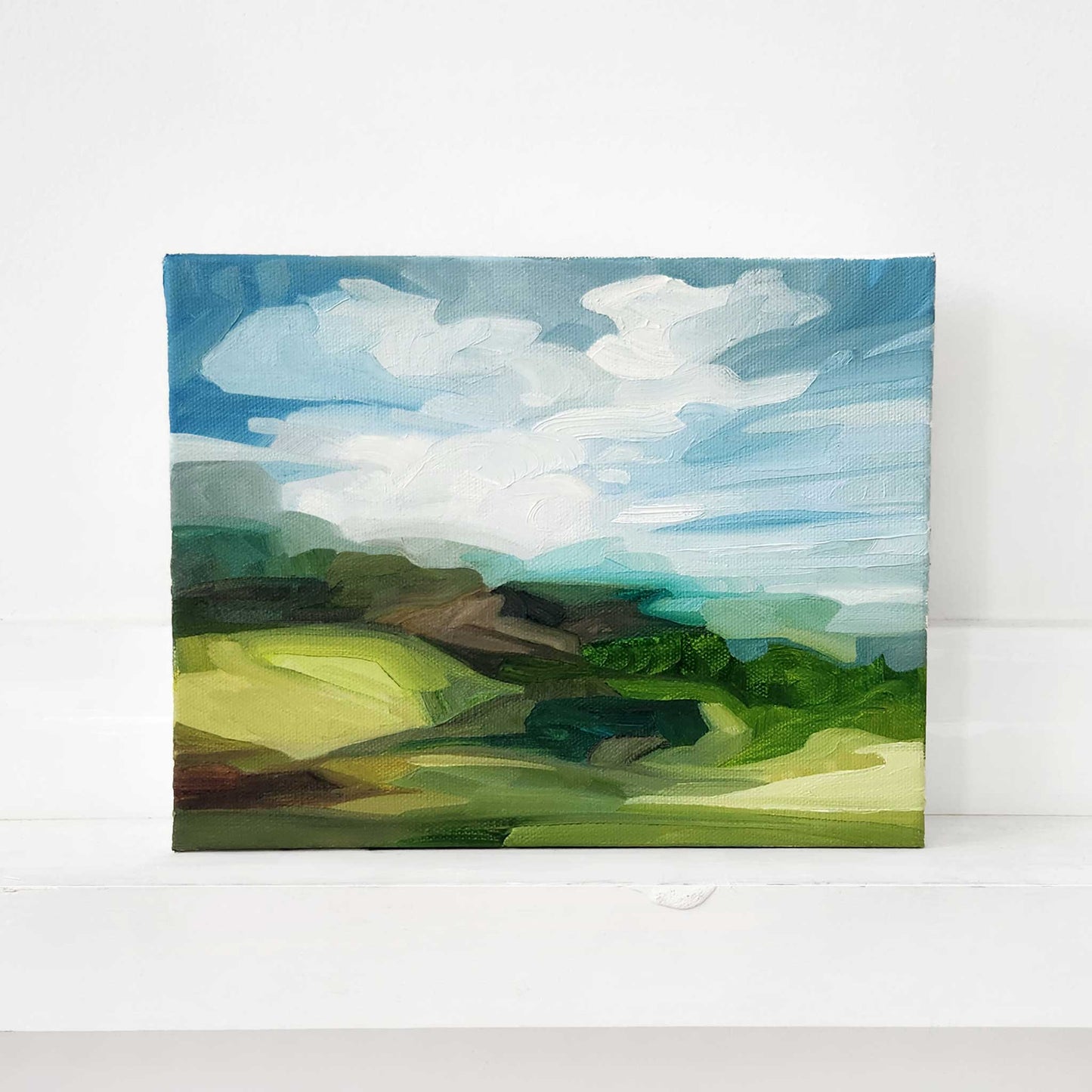 Contemporary oil painting of green hills in a vibrant summer landscape.