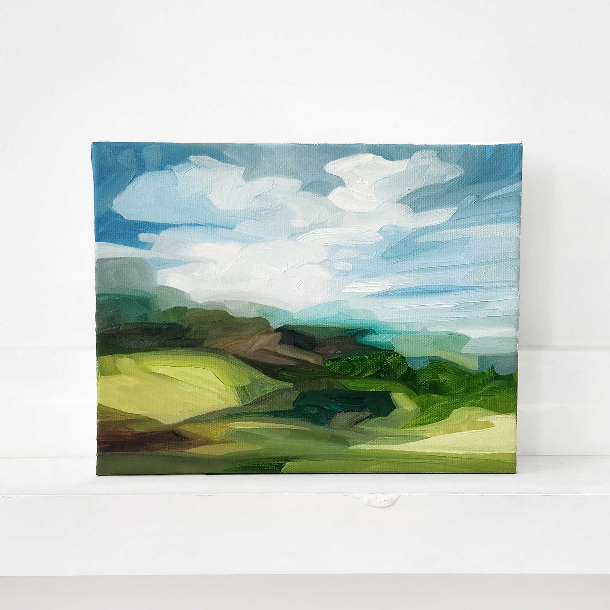 Contemporary oil painting of green hills in a vibrant summer landscape.