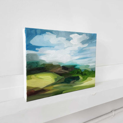 Original oil painting of rolling green hills in a vibrant summer landscape.