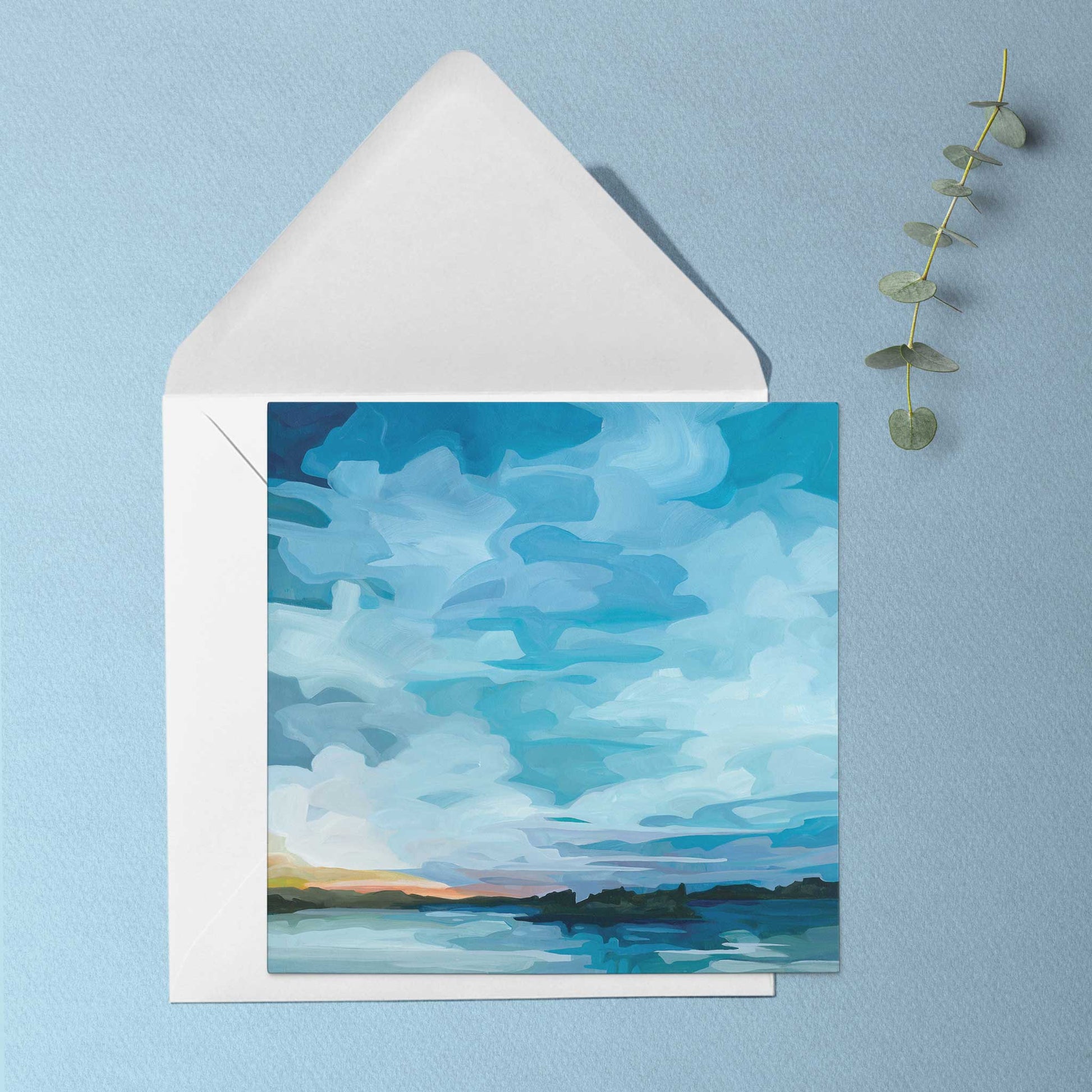Nature inspired greeting card featuring glowing sunset light across still lake water beneath an impossibly blue evening sky