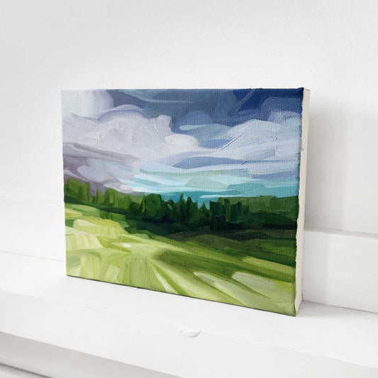 Original oil painting of a woodland landscape with a distant horizon and dramatic sky.