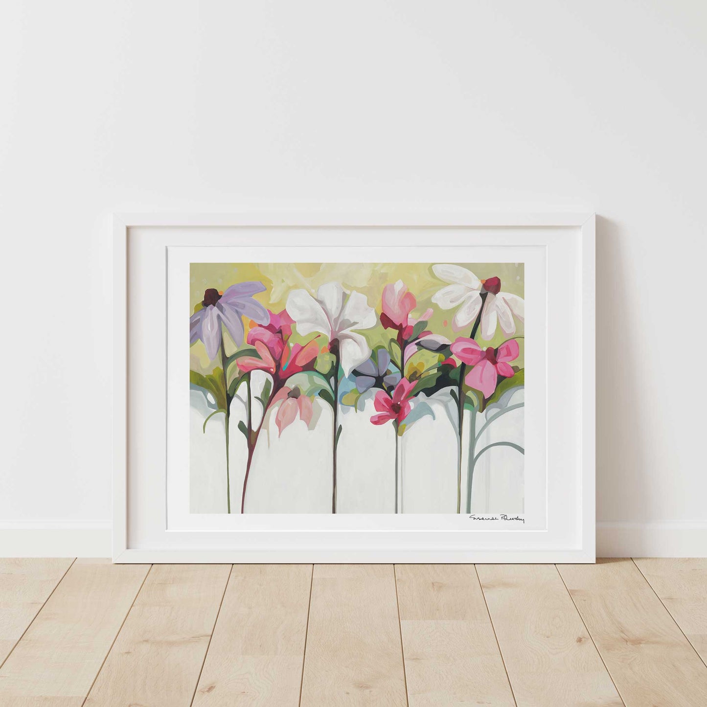 Horizontal acrylic flower painting print of vibrant garden flowers framed and leaning against wall