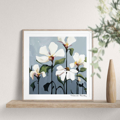 Small framed acrylic flower painting art print with creamy white blossoms on soft grey background standing on a shelf