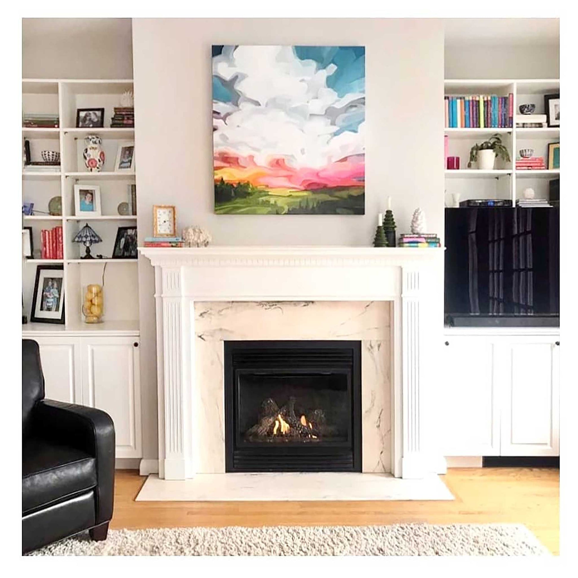 acrylic sky painting original artwork hung in living room over fireplace