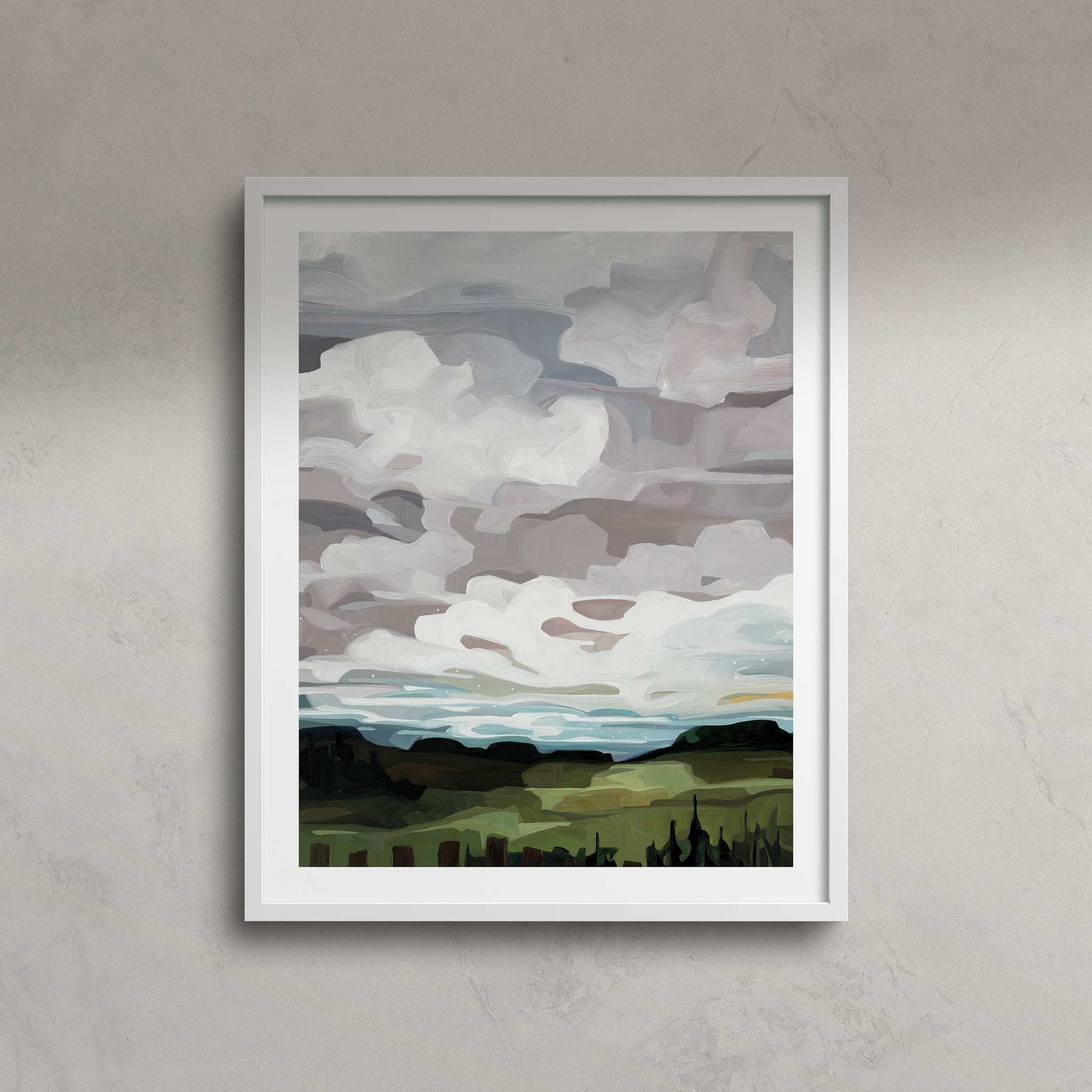 An framed vertical art print of an abstract landscape created from a warm grey painting with a muted palette of soft greys and greens with white billowy clouds light blue sky