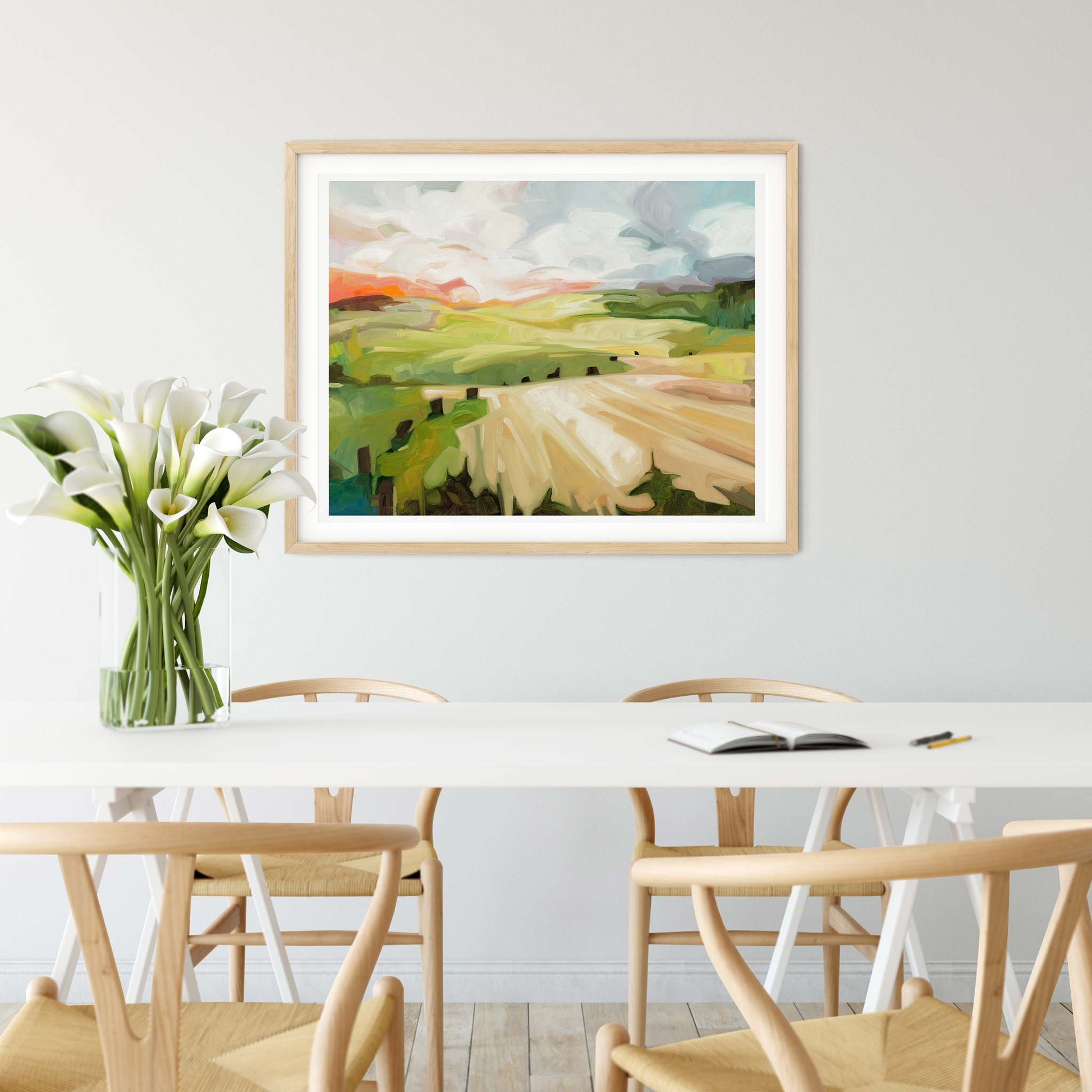 large horizontal art print of an abstract landscape artwork over dining table