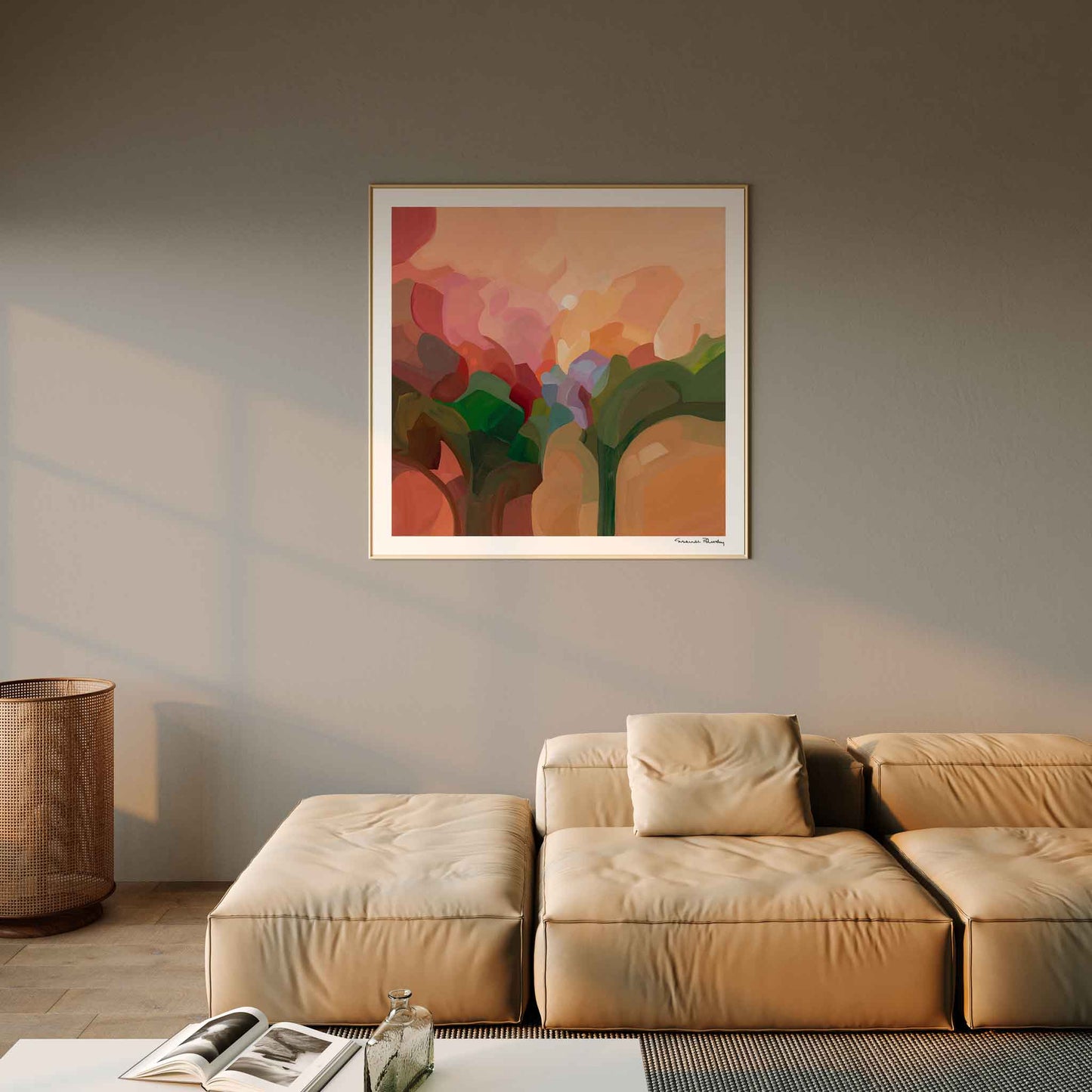 large square peach abstract art print hanging in living room