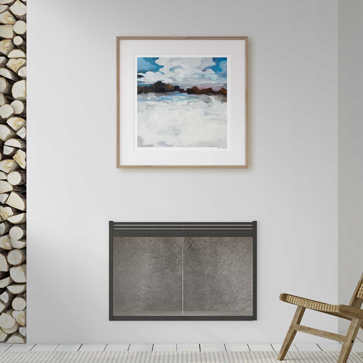 large square art print hanging over fireplace with framed winter abstract landscape in white room