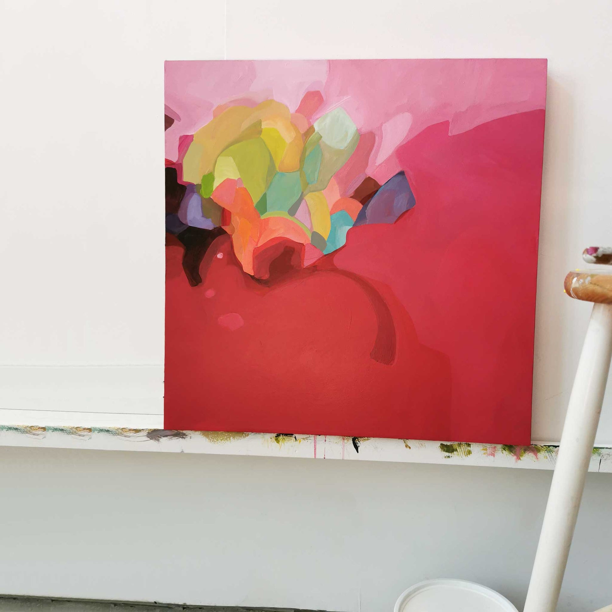 raspberry red acrylic abstract painting in studio on canvas