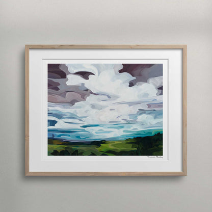 framed horizontal art print of an acrylic abstract painting of a landscape with a bright turquoise cloud-filled evening sky