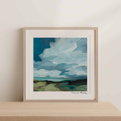 framed square art print of outlander an abstract landscape acrylic sky painting standing on a shelf