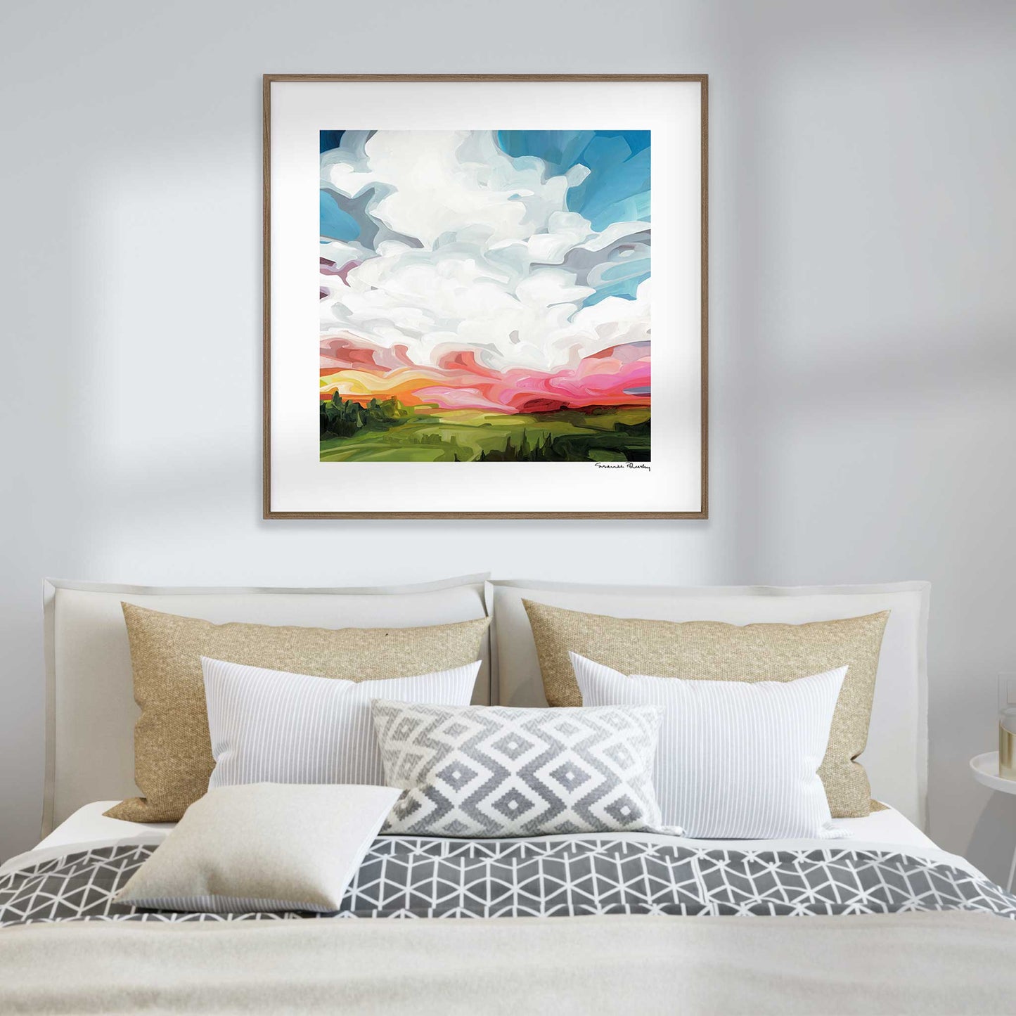 framed sky painting art print hanging as wall art over bed
